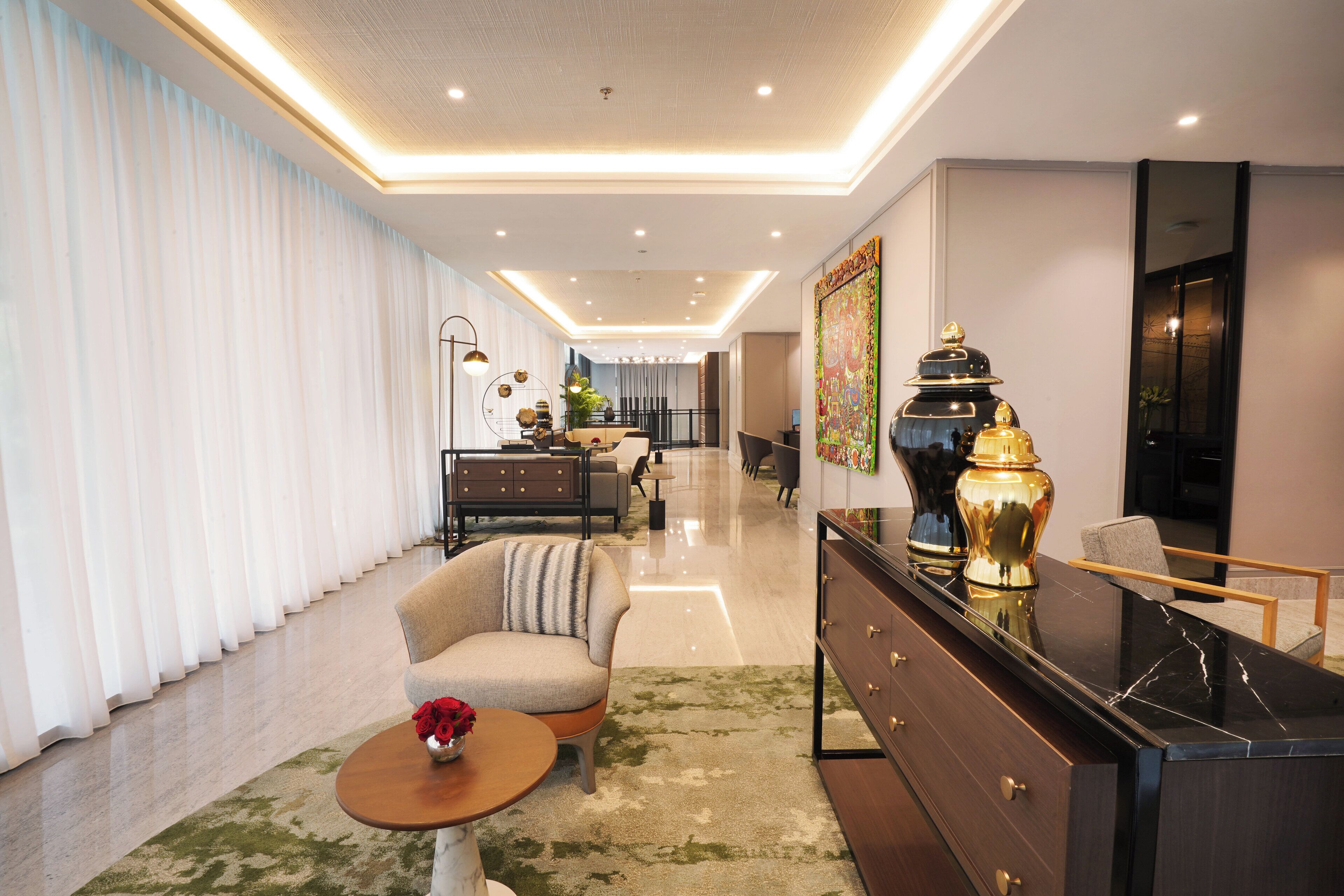 A modern living room with a sofa, a coffee table, and a decorative vase.