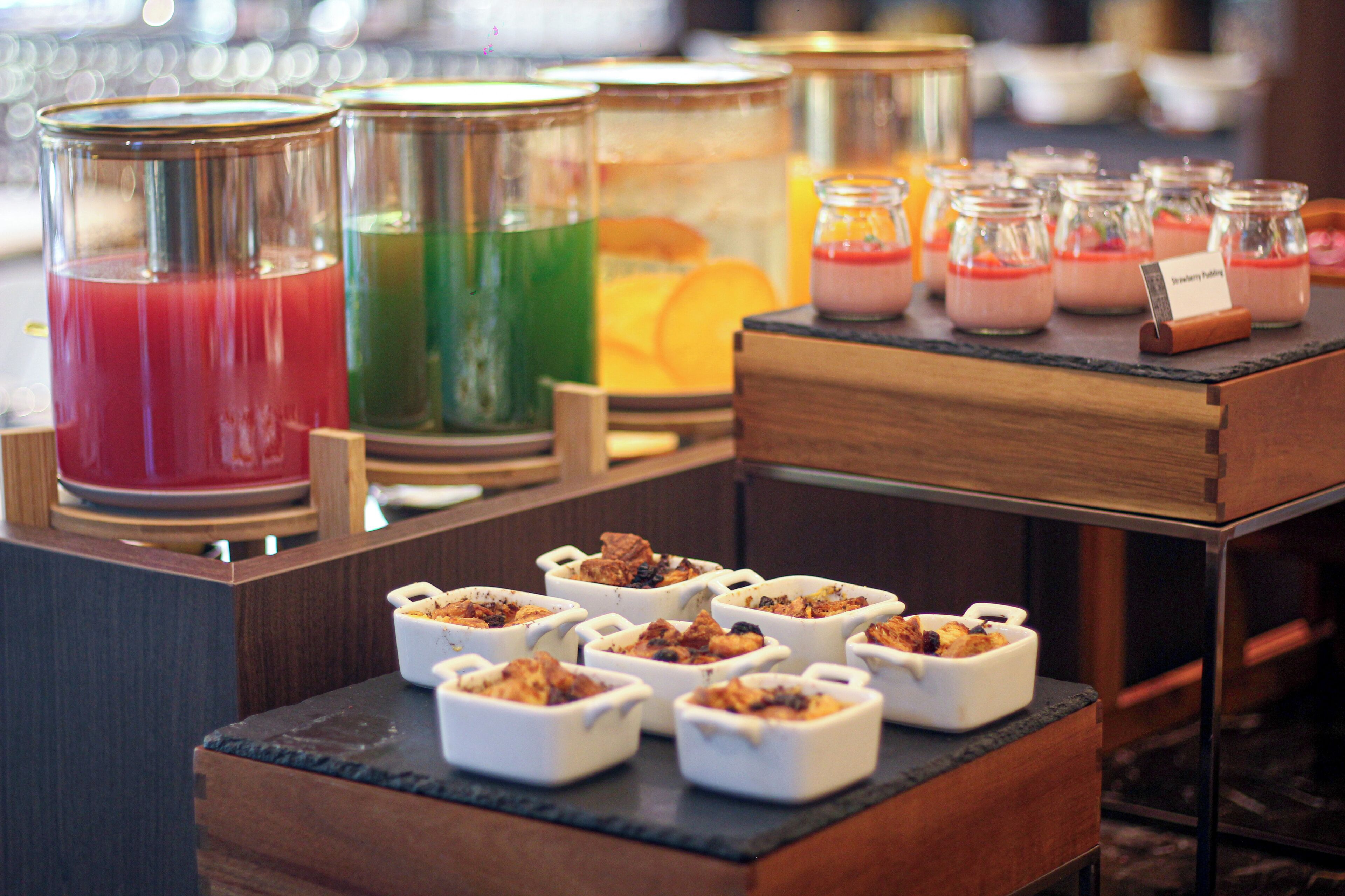 A buffet with various food items and beverages.