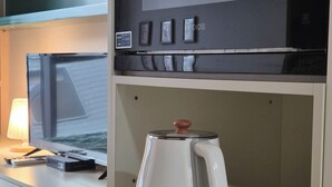 A kitchenette with a coffee maker, a microwave, and a small refrigerator. - 27 l Myeongdong 5min l Airport bus l Cozy Room (Seoul)