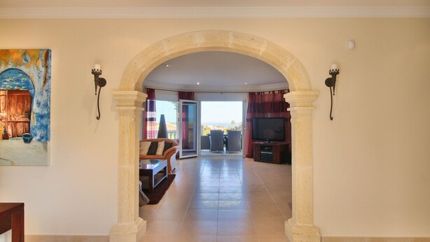 A spacious living area with a stone archway leading to a balcony. - Spectacular villa with private pool and sea views in Denia (Denia)