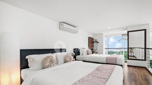 A modern hotel room with two beds, a large window, and a balcony with a view. - Galena by Kozystay - Alam Sutera (South Tangerang)