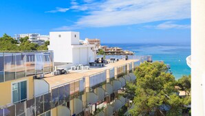 A coastal building with multiple balconies, air conditioning units, and a clear view of the sea. - 602 Cala Forn Salou Side sea views w Direct access to the beach (Salou)