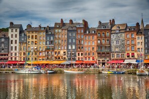 A waterfront with historic buildings and boats.