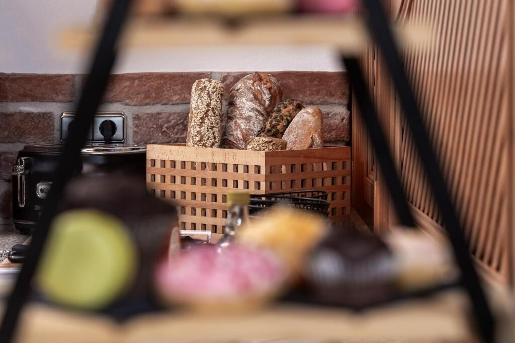 A wooden crate with various breads and a small stove in the background.