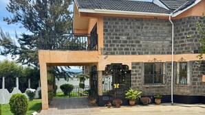 A two-story building with a tiled roof, a balcony, and a gated entrance. - Lux Suites Lakeview Mansion Nakuru (Nakuru)