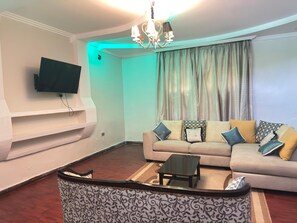 Family Bungalow, Balcony, Garden View | Living area | 24-inch Smart TV with digital channels - Lux Suites Lakeview Mansion Nakuru (Nakuru)