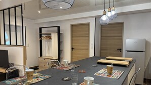A modern conference room with a long table, chairs, and a refrigerator. - Modern 3-ears cottage in Cognat-Lyonne, 6 ppl, charm and comfort (Cognat-Lyonne)