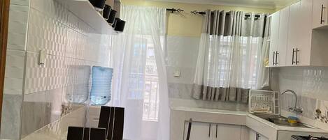 Deluxe Apartment, City View | Private kitchen | Fridge, microwave, cookware/dishes/utensils