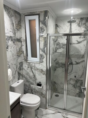 Shower, towels, soap, toilet paper