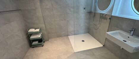 Un baño moderno con ducha, inodoro y lavamanos.