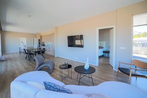 Luxury Apartment, Balcony | Living area | 32-inch LCD TV with cable channels - Hofsbót Luxury apartment (Akureyri)