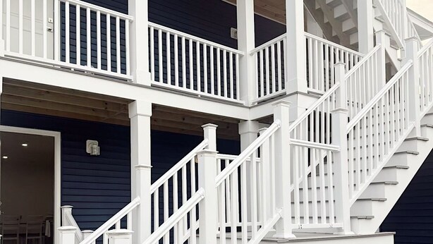 A multi-level wooden staircase with white railings leading to a porch area. - Shore Thing Wildwood (Wildwood)