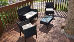 A deck with wicker furniture including a sofa, two chairs, and a coffee table. - Your Southern Getaway, Sleeps 10・Games, Fire pit (Sevierville)