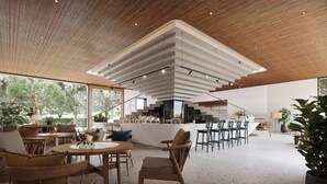 A modern interior with a dining area, bar, and kitchen. - Villa Qabalah (Si Sunthon)