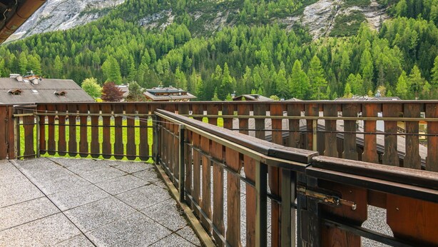 A wooden balcony with a view of a mountainous landscape. - Nice apartment for 3 people with terrace (Canazei)