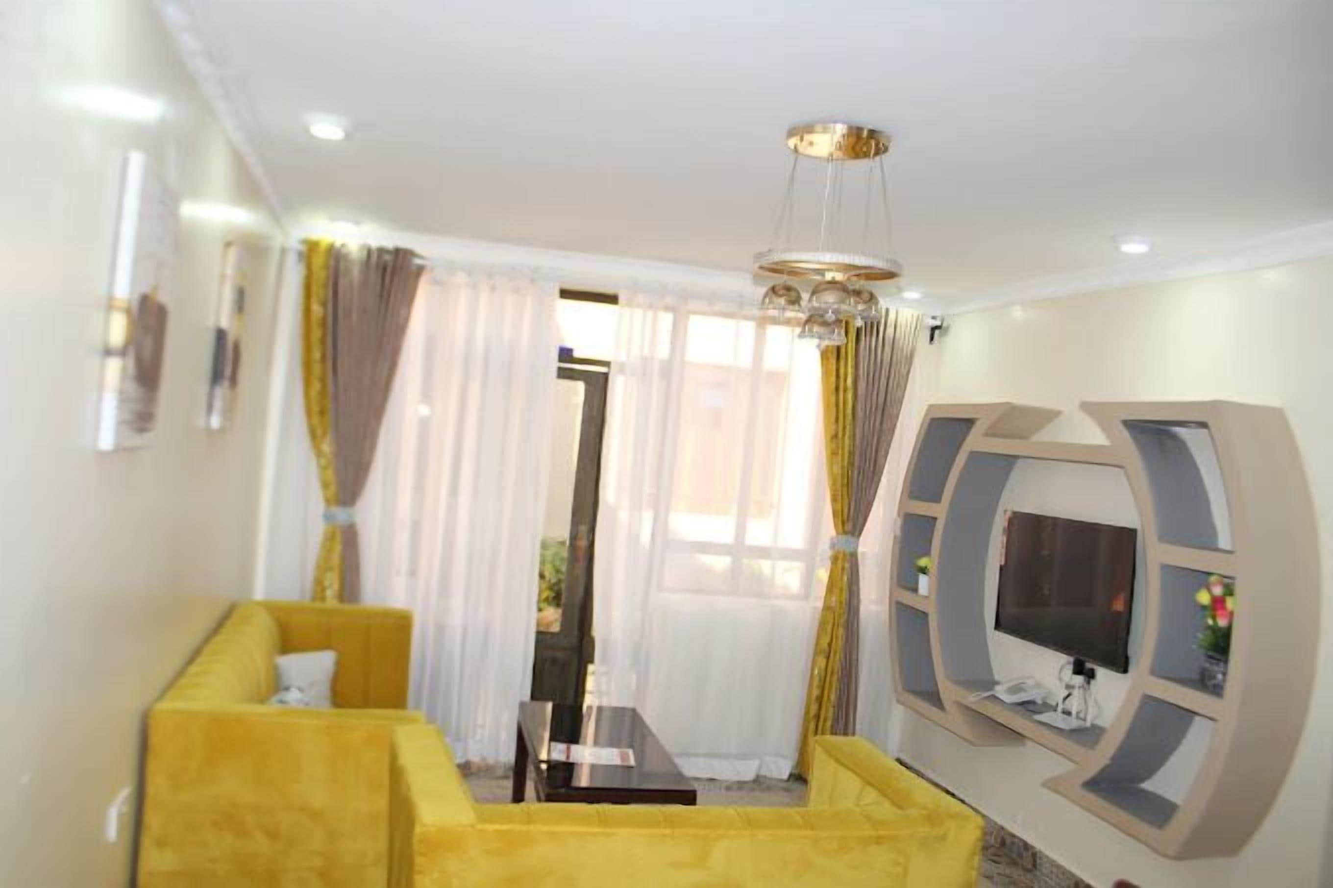 Family Apartment, City View | Living area | 24-inch Smart TV with digital channels