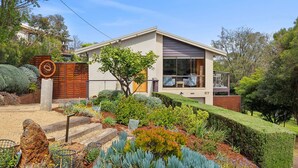 A modern two-story house with a well-maintained garden, a visible number '37' on the side, and a large window on the second floor. - BeachHaven (Aireys Inlet)