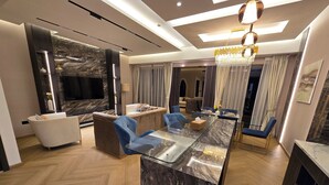 A modern living room with a marble island, sofas, and a TV. - Highend Luxury Rimal with JBR view (Dubai)