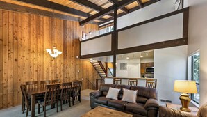 A wooden interior with a dining area, a sofa, and a lamp. - Family Tahoe Retreat: Beach, Pool & Hot Tub LLV401 (South Lake Tahoe)