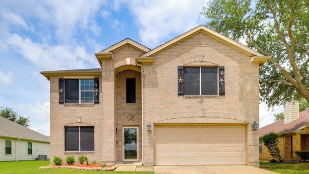 A two-story house with a garage, a front entrance, and a small front yard. - 7 Mi to Downtown Baytown: Spacious Home w/ Yard (Baytown)