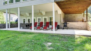 A covered patio with outdoor seating, a barbecue grill, and a view of the house's exterior. - < 1 Mi to Marina: Fair Play Home on Lake Hartwell (Fair Play)