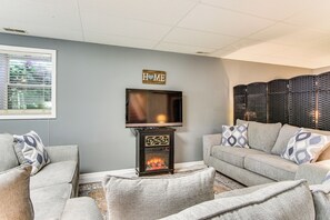 A living room with a fireplace, a television, and a 'HOME' sign on the wall. - < 1 Mi to Marina: Fair Play Home on Lake Hartwell (Fair Play)