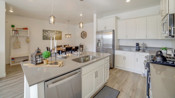 A modern kitchen with white cabinetry, stainless steel appliances, and pendant lighting. - Patio, Park & Peace: 'skyview Landing' in Eagle! (Eagle)
