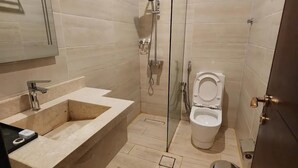 Un baño moderno con un lavamanos grande, inodoro y zona de ducha.