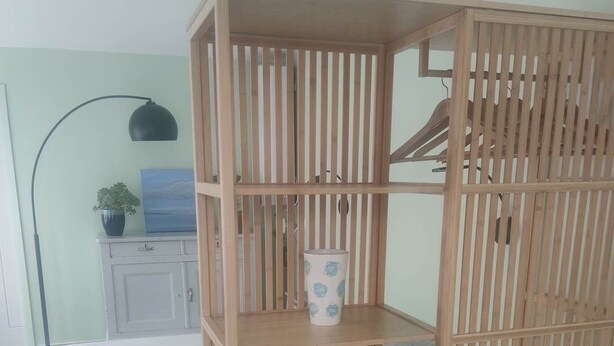 A room with a bed, a wooden wardrobe with shelves, a lamp, and a plant. - Maison Réthaise 1 city center Garden mix art/flowers (LA FLOTTE)
