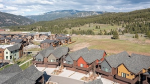 A residential area with modern houses featuring sloped roofs and multiple stories.