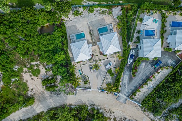 The aerial shot shows the spacious property and private pools.