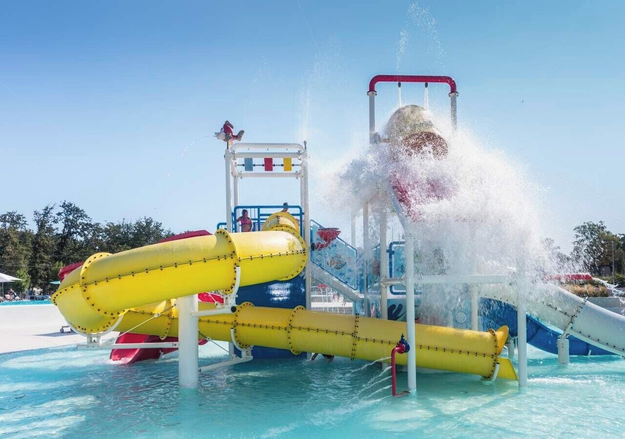 A water play area with slides and a water jet.