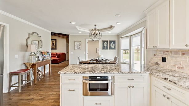 A spacious kitchen with white cabinetry, a granite countertop, and a built-in oven. - Peaceful Horse Ranch Escape Near Palo Duro Canyon 3 Bedroom Home (Canyon)