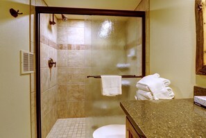 A bathroom with a glass-enclosed shower, a toilet, and a sink with a towel rack. - Wl210 West Lake Lodge 2 Bedroom Condo (Copper Mountain)