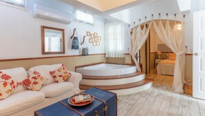 A modern bathroom with a bathtub, a shower area, and a vanity. - Mon Ilıca Otel (Cesme)