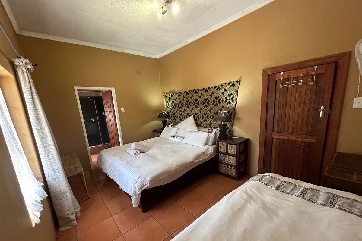 A bedroom with a bed, a nightstand, and a wardrobe.
