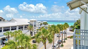 A coastal hotel with a view of the ocean, palm trees, and a parking area. - ☀️Gulf Views-Updated-3 Pools-30A-Gulf Place Town Center 421☀️ (Santa Rosa Beach)