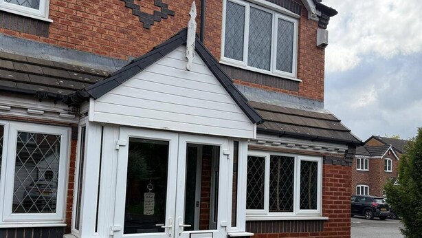 A two-story house with a white front door, brick exterior, and a small porch. - Deluxe Double Room in Birmingham (West Midlands)