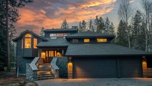 A modern two-story house with a stone staircase, a garage, and a driveway. - Blue Goose in Sunriver Resort (Sunriver)