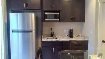 Fridge, microwave, coffee/tea maker, cookware/dishes/utensils