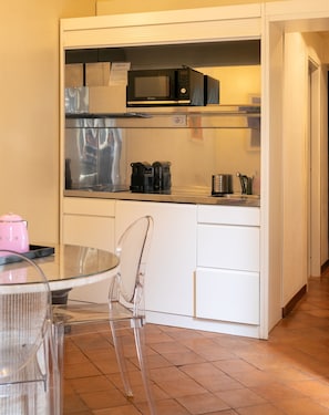 Superior Studio Suite, City View | Private kitchen | Electric kettle, highchair