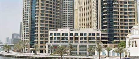 A high-rise building with multiple floors, large windows, and a modern architectural design.