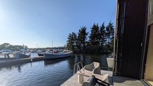 Eine hölzerne Anlegestelle mit einem Boot namens 'Echizen' in einer Marina, umgeben von Bäumen und anderen Booten.