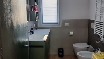 Een haardroger, handdoeken, zeep, toiletpapier