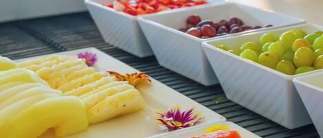 A buffet with various fruits and vegetables.