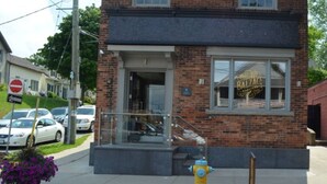 A brick building with a glass storefront and a fire hydrant in front. - Bob's Yer Uncle in Port Dalhousie (St. Catharines)