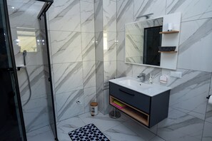 Shower, hair dryer, towels, toilet paper