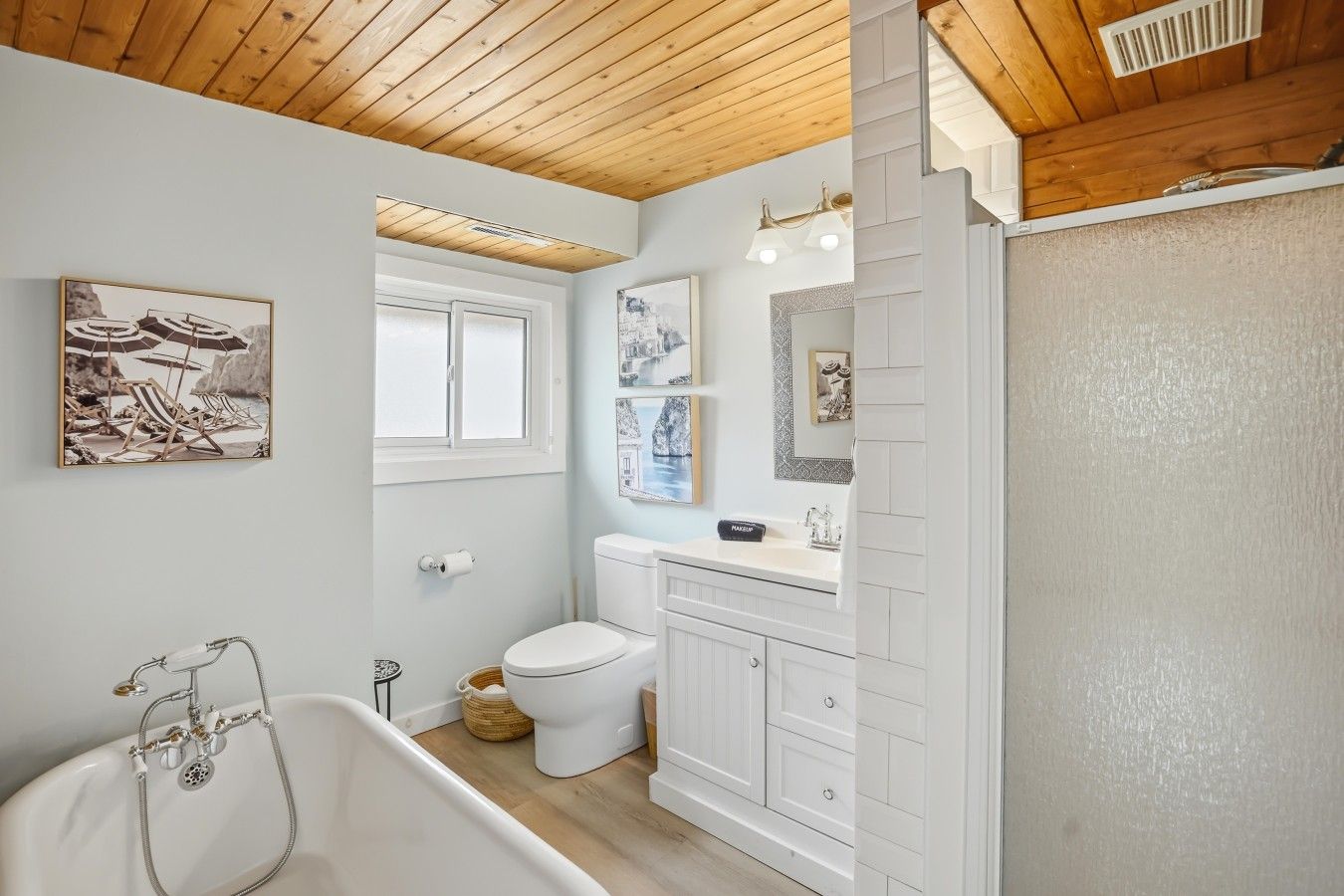 A bathroom with a bathtub, toilet, and vanity.