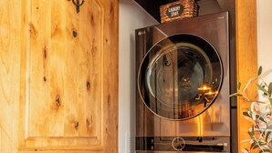 A wooden door with a metal laundry basket on top.