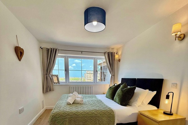 This bedroom offers a functional cabinet, perfect for storing your belongings and keeping the room neat.